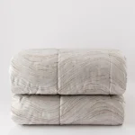 TRAPUNTA IN JACQUARD CON LINEE MODERNE